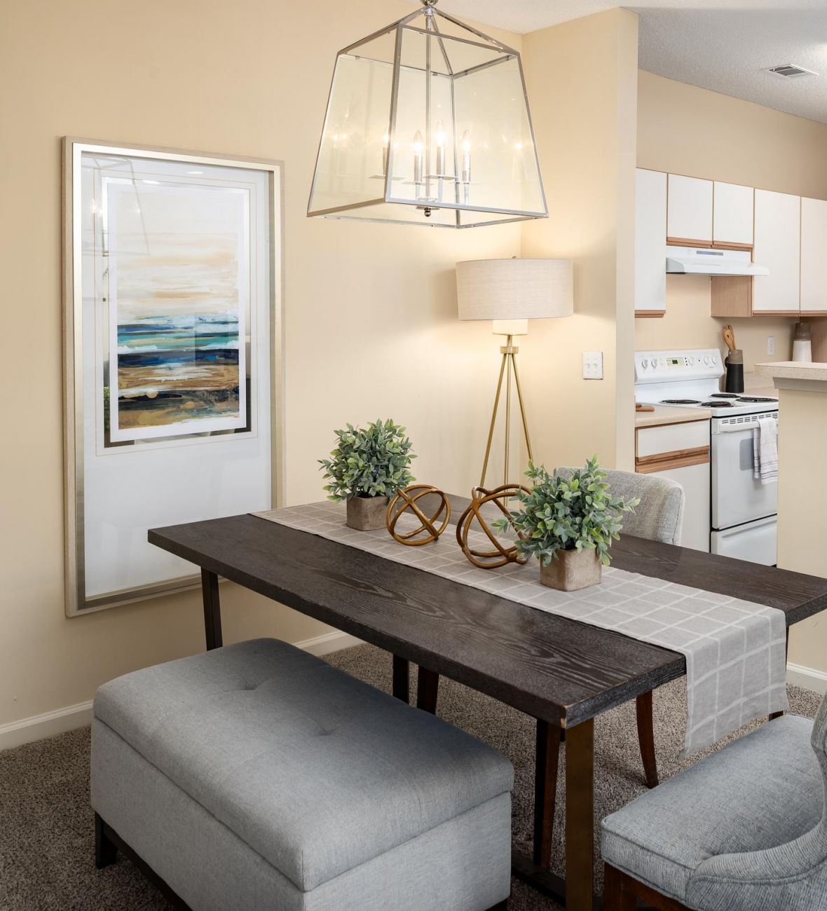 Cedar Grove apartment homes with Modern apartment kitchen and dining area with wooden table, upholstered chairs, and neutral decor.